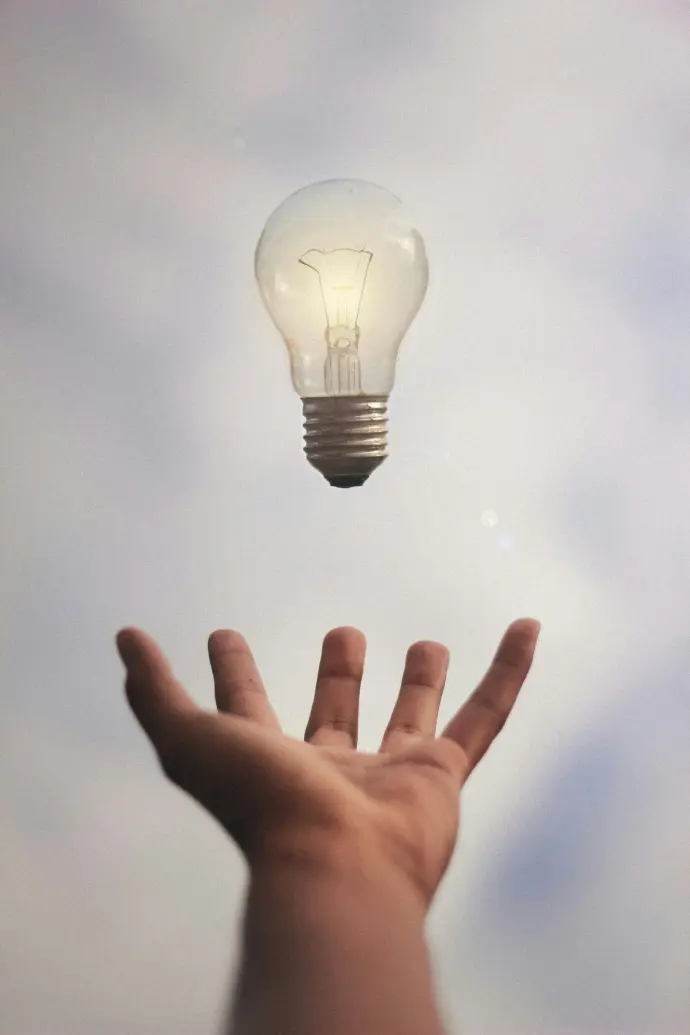 Person catching a light bulb symbolizing enterprise innovation and digital flow with ArchOps